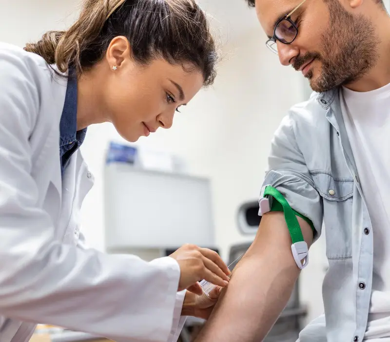 Female pharmacist taking mans blood pressure